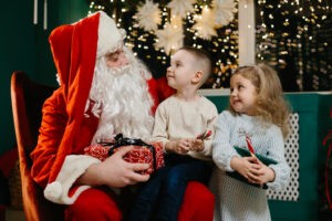 Santa Claus gifting presents to excited children in a warm Christmas atmosphere